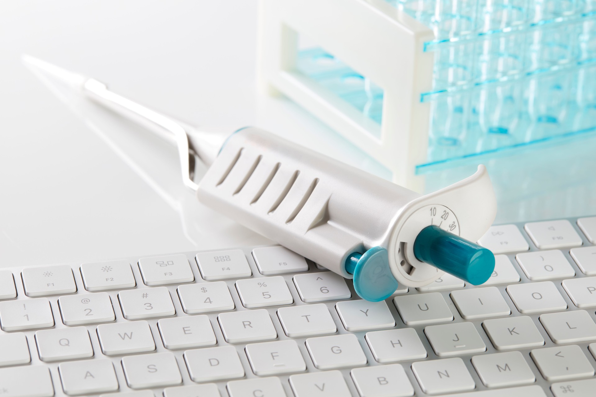 Pipette and test tubes on keyboard